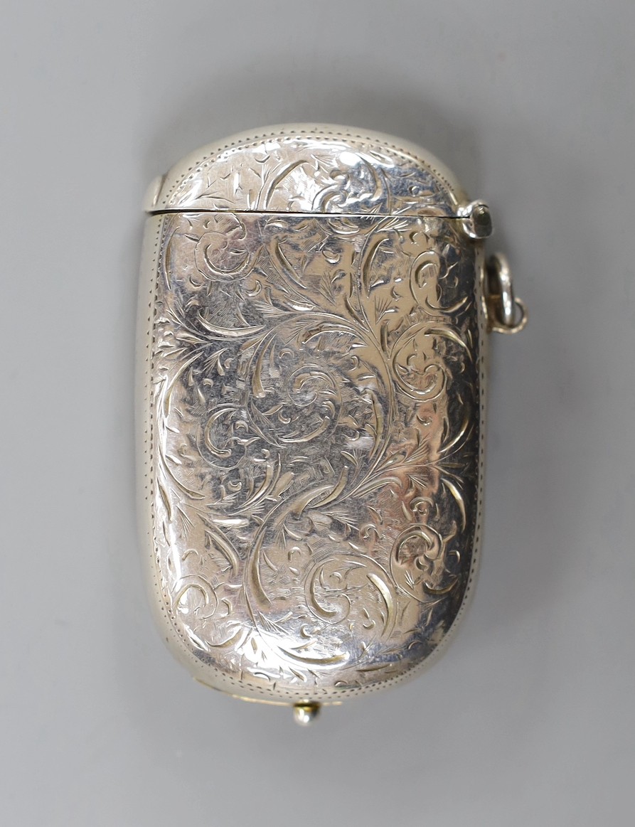 A late Victorian engraved silver combination sovereign, vesta and stamp case, the interior with removable toothpick and pencil, William Neale Ltd, Birmingham, 1897, 63mm.
